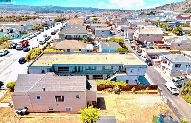 an aerial view of a house with a swimming pool yard and outdoor seating