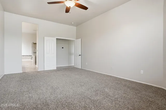 an empty room with a empty space and a ceiling fan