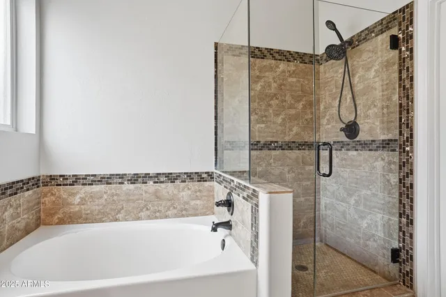 a bathroom with a bath tub and shower