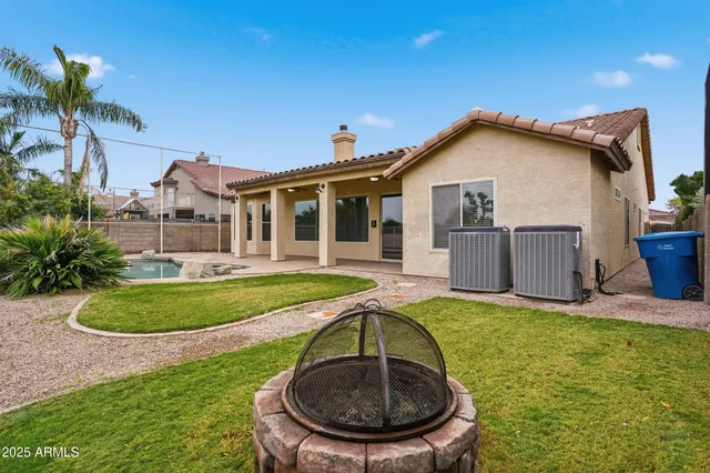 a view of a house with a swimming pool and a yard