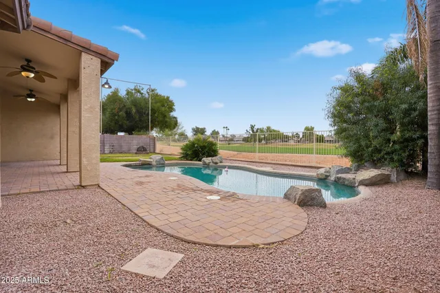 a view of a swimming pool with a patio