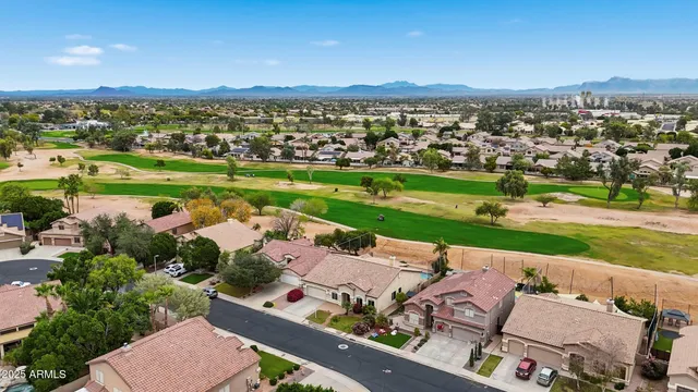 an aerial view of a residential houses with outdoor space and lake view
