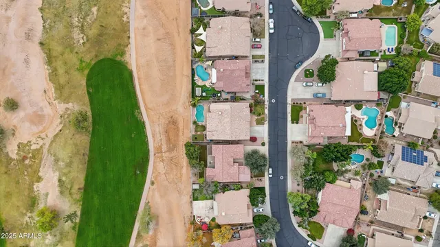 an aerial view of residential houses with outdoor space