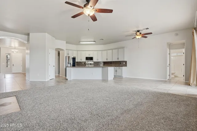 a view of a kitchen with a sink and a refrigerator