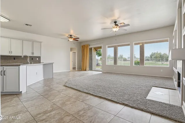a living room with granite countertop furniture and a chandelier