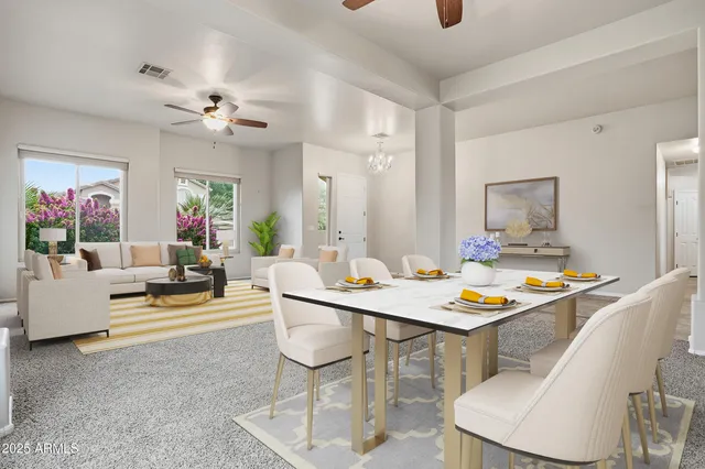 a view of a dining room with furniture and a chandelier fan