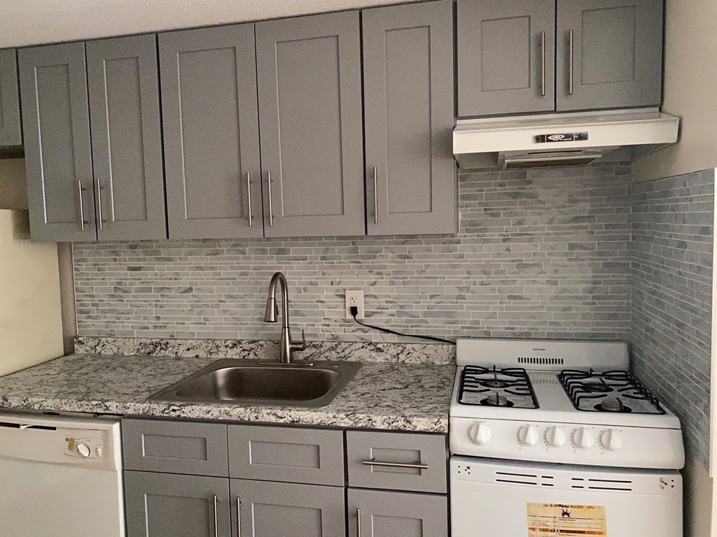 424 Great Road, Unit 15 Acton, MA 01720 - Photo 4 of 9 a kitchen with stainless steel appliances and cabinets