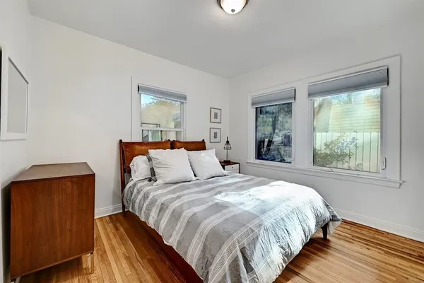 a bedroom with a bed and window