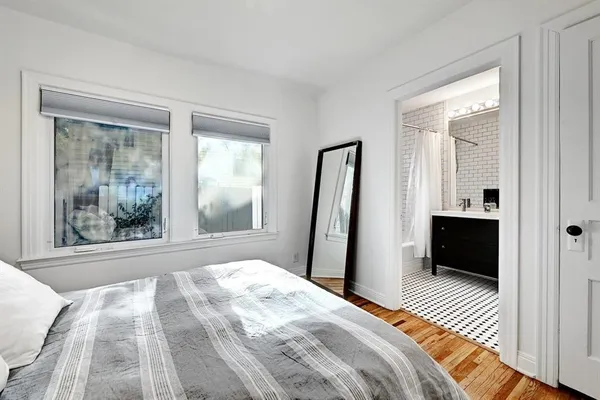 a bedroom with a bed and a window