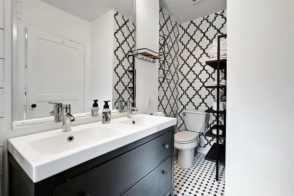 a bathroom with a sink a toilet and mirror