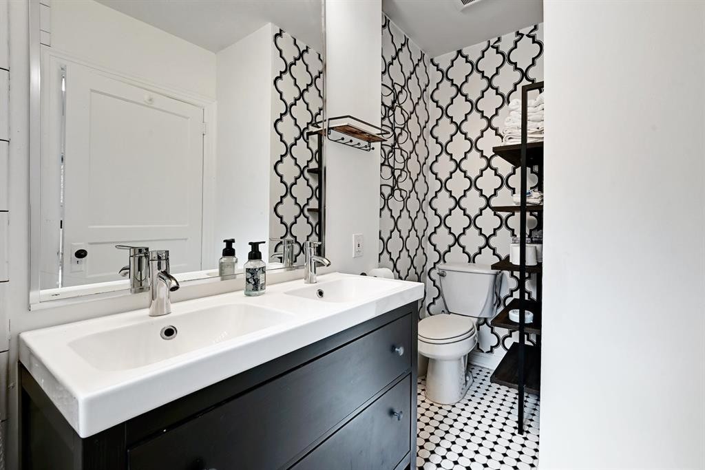 2943 Higgins Street Austin, TX 78722 - Photo 16 of 21 a bathroom with a sink a toilet and mirror