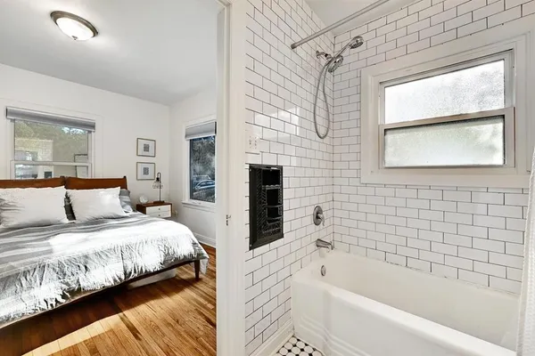 a bedroom with a bed and a window