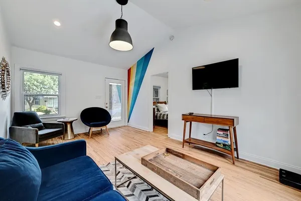a living room with furniture and a flat screen tv