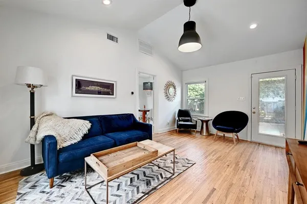 a living room with furniture and wooden floor