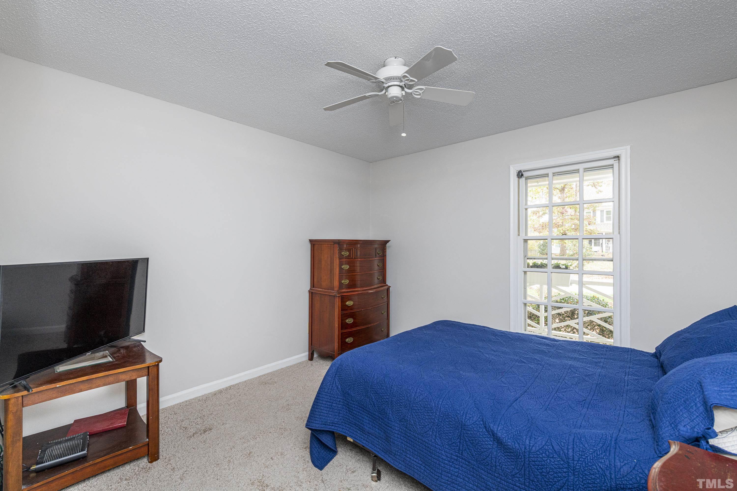 11913 North Exeter Way Raleigh, NC 27613 - Photo 23 of 29 a bedroom with a bed and a flat screen tv