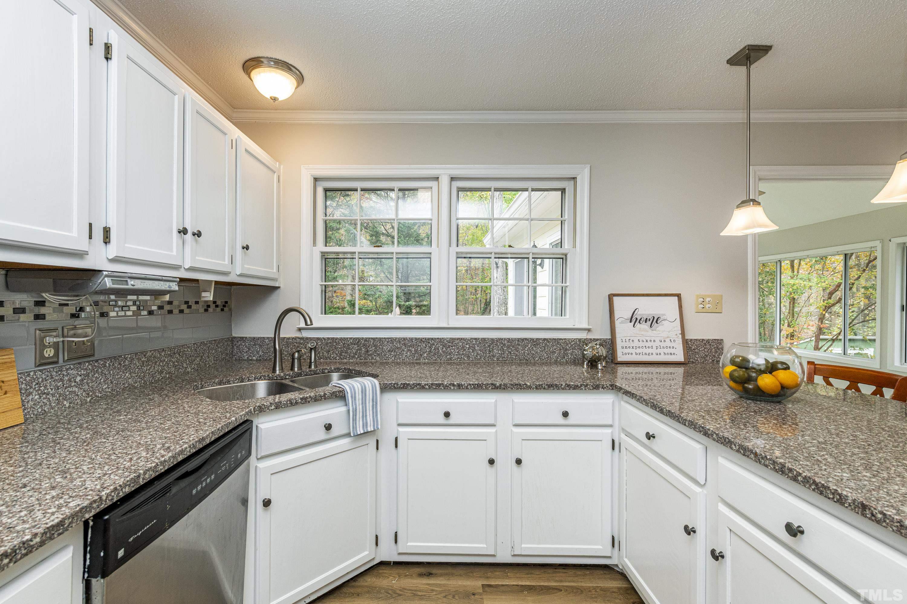 11913 North Exeter Way Raleigh, NC 27613 - Photo 8 of 29 a kitchen with stainless steel appliances granite countertop a sink and a counter space
