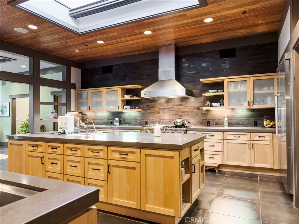 865 West Foothill Boulevard Arcadia, CA 91006 - Photo 16 of 44 a kitchen with stainless steel appliances granite countertop a sink a stove and a wooden cabinets