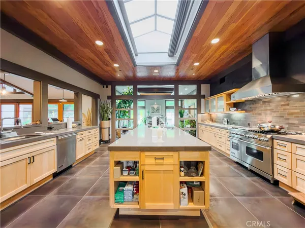 a kitchen with stainless steel appliances granite countertop a stove and a sink