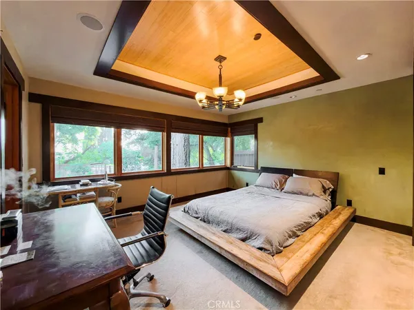 a bedroom with a bed and a chandelier