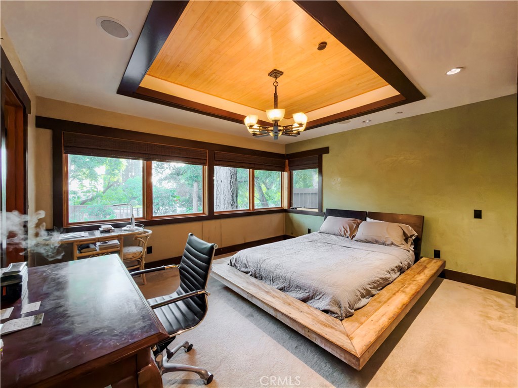 865 West Foothill Boulevard Arcadia, CA 91006 - Photo 29 of 44 a bedroom with a bed and a chandelier