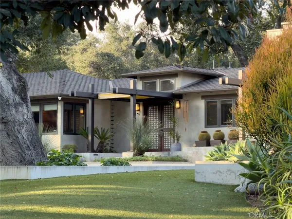 a front view of a house with garden