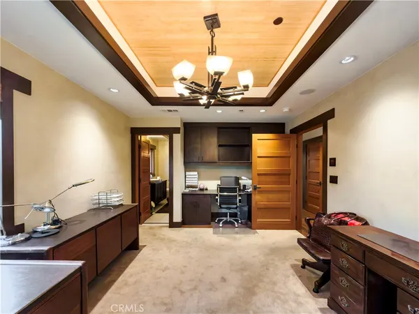 a view of a workspace with furniture and a chandelier