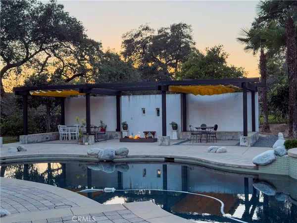 an aerial view of a house with swimming pool and garden view