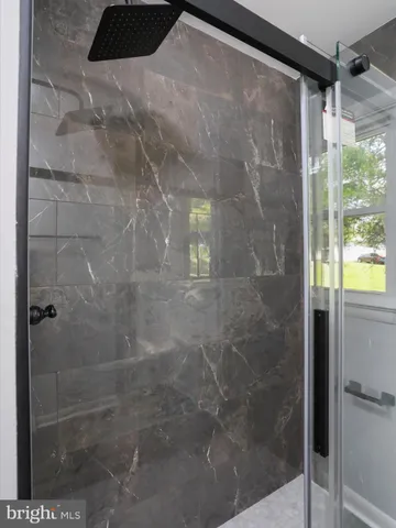a bathroom with a glass shower door
