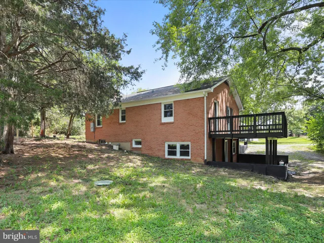 a view of a house with a yard and sitting area