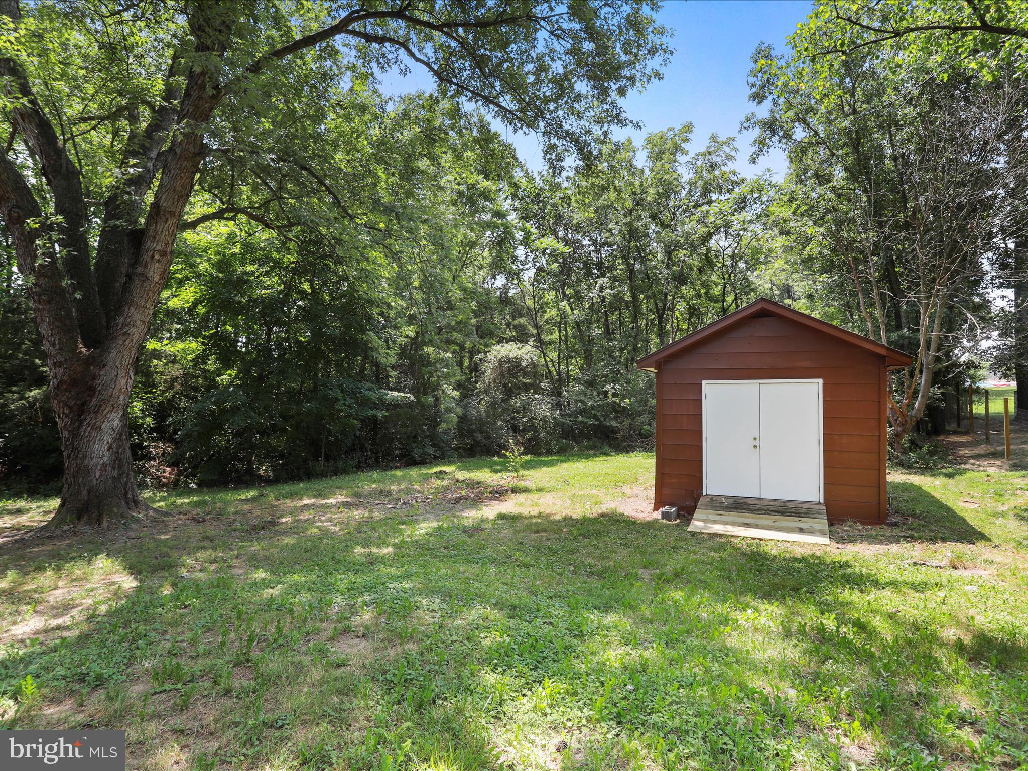 115 Blue Ridge Lane White Post, VA 22663 - Photo 31 of 35 a view of a wooden house with a yard and large trees
