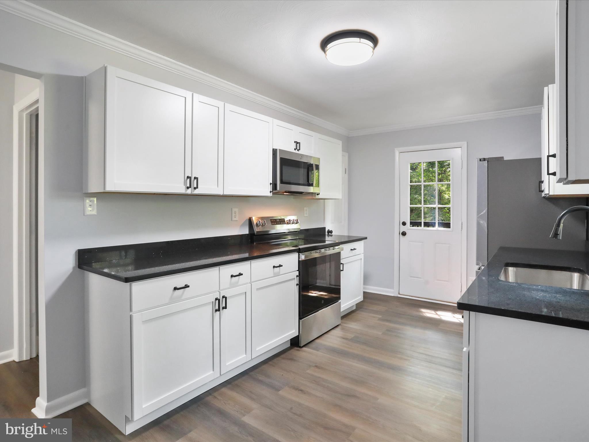 115 Blue Ridge Lane White Post, VA 22663 - Photo 4 of 35 a kitchen with granite countertop a stove a sink and a granite counter tops