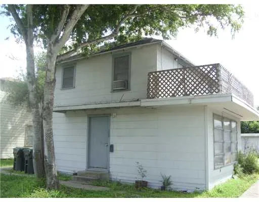 a side view of a house with a yard
