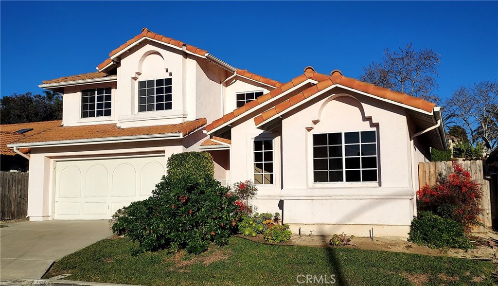 2186 Luz Way Oceanside, CA 92056 - Photo 1 of 24 a view of a white house with large windows and a yard
