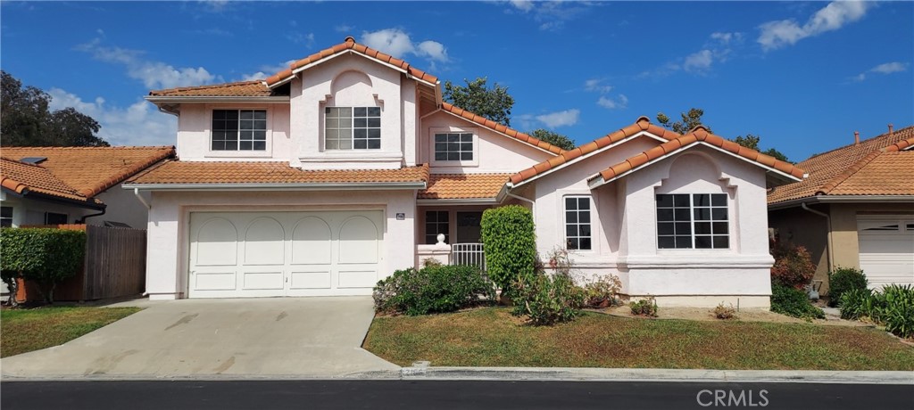 2186 Luz Way Oceanside, CA 92056 - Photo 2 of 24 a front view of a house with a yard and garage
