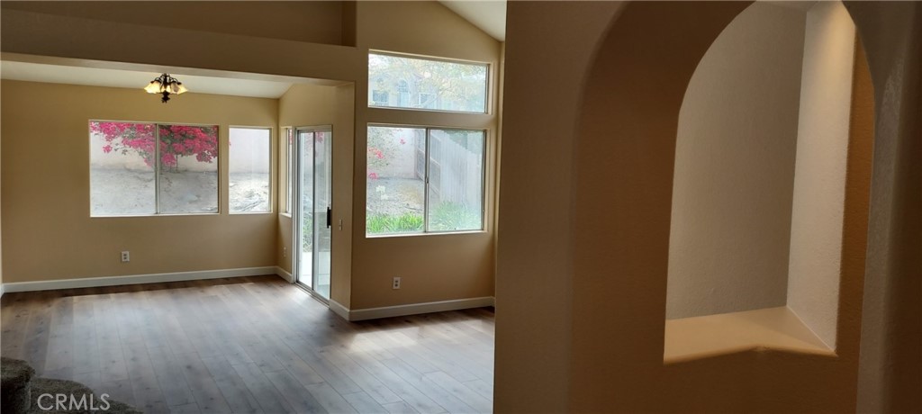 2186 Luz Way Oceanside, CA 92056 - Photo 3 of 24 an empty room with wooden floor and windows