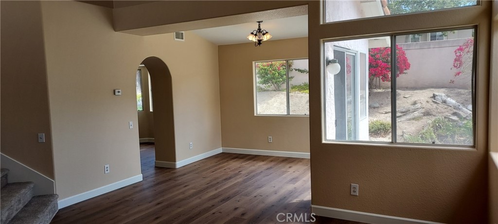2186 Luz Way Oceanside, CA 92056 - Photo 4 of 24 an empty room with wooden floor and windows