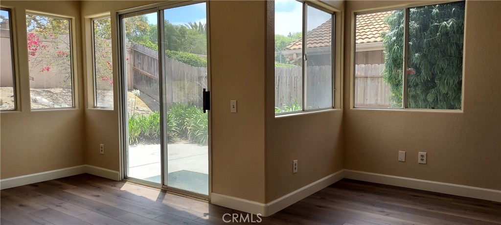 2186 Luz Way Oceanside, CA 92056 - Photo 6 of 24 a view of an empty room and wooden floor and windows