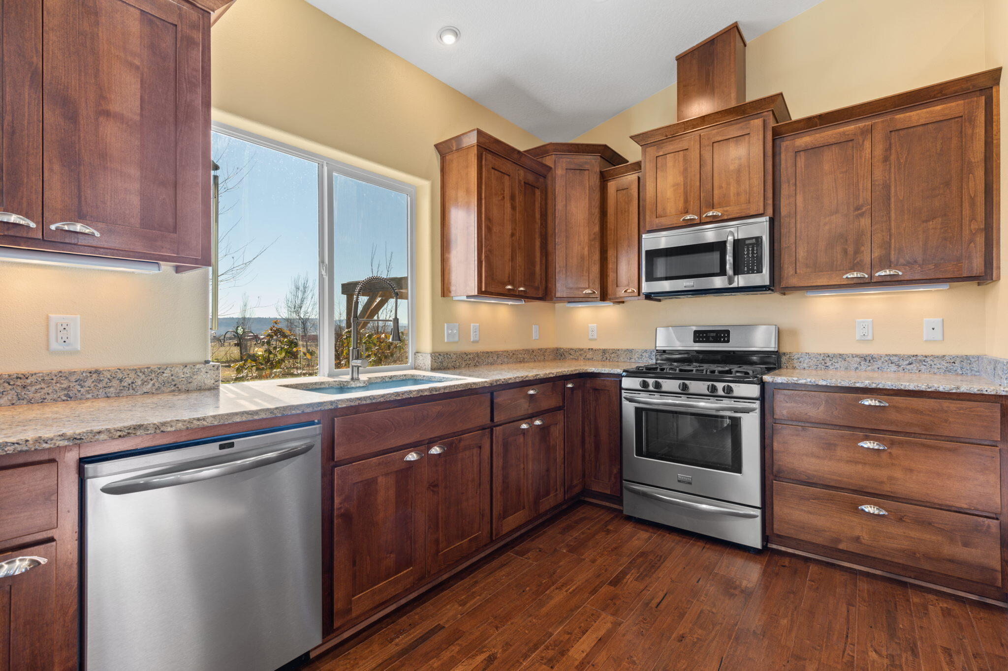 3923 Beagle Road White City, OR 97503 - Photo 12 of 31 a kitchen with stainless steel appliances granite countertop a stove a sink and a microwave