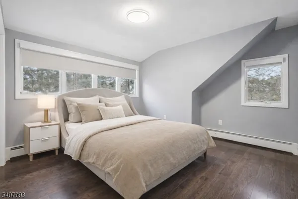 a large bed sitting in a bedroom next to a window