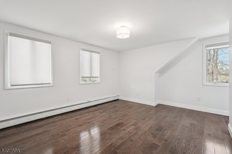 20 Fairmount Road New Providence, NJ 07974 - Photo 16 of 23 an empty room with wooden floor and windows