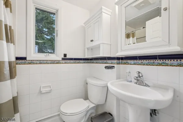 a bathroom with a sink a mirror and a toilet