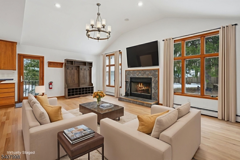 20 Fairmount Road New Providence, NJ 07974 - Photo 3 of 23 a living room with furniture a fireplace and a flat screen tv