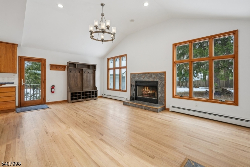 20 Fairmount Road New Providence, NJ 07974 - Photo 4 of 23 a view of an empty room with wooden floor fireplace and a window