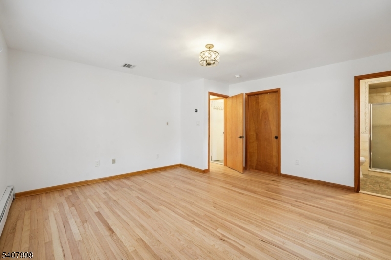 20 Fairmount Road New Providence, NJ 07974 - Photo 8 of 23 a view of an empty room with wooden floor and a window