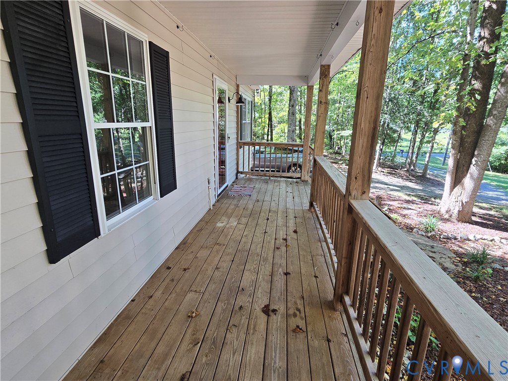 2578 Bagby Road Bumpass, VA 23024 - Photo 2 of 26 Expansive wooden porch with a natural wood railing