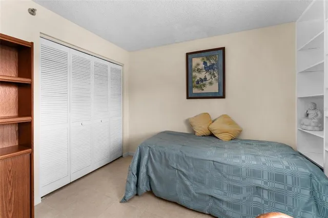 a bedroom with a bed and a cabinets