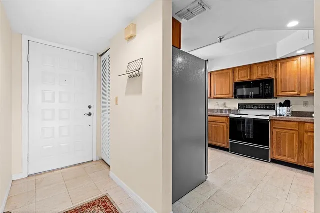 a kitchen with stainless steel appliances a refrigerator and a stove top oven