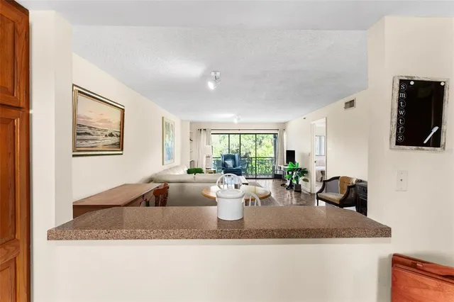 a kitchen with a granite counter top couches and a flat screen tv