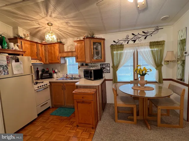 a kitchen with stainless steel appliances granite countertop a sink and a refrigerator