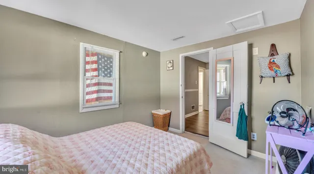 a bedroom with a bed and a wooden floor